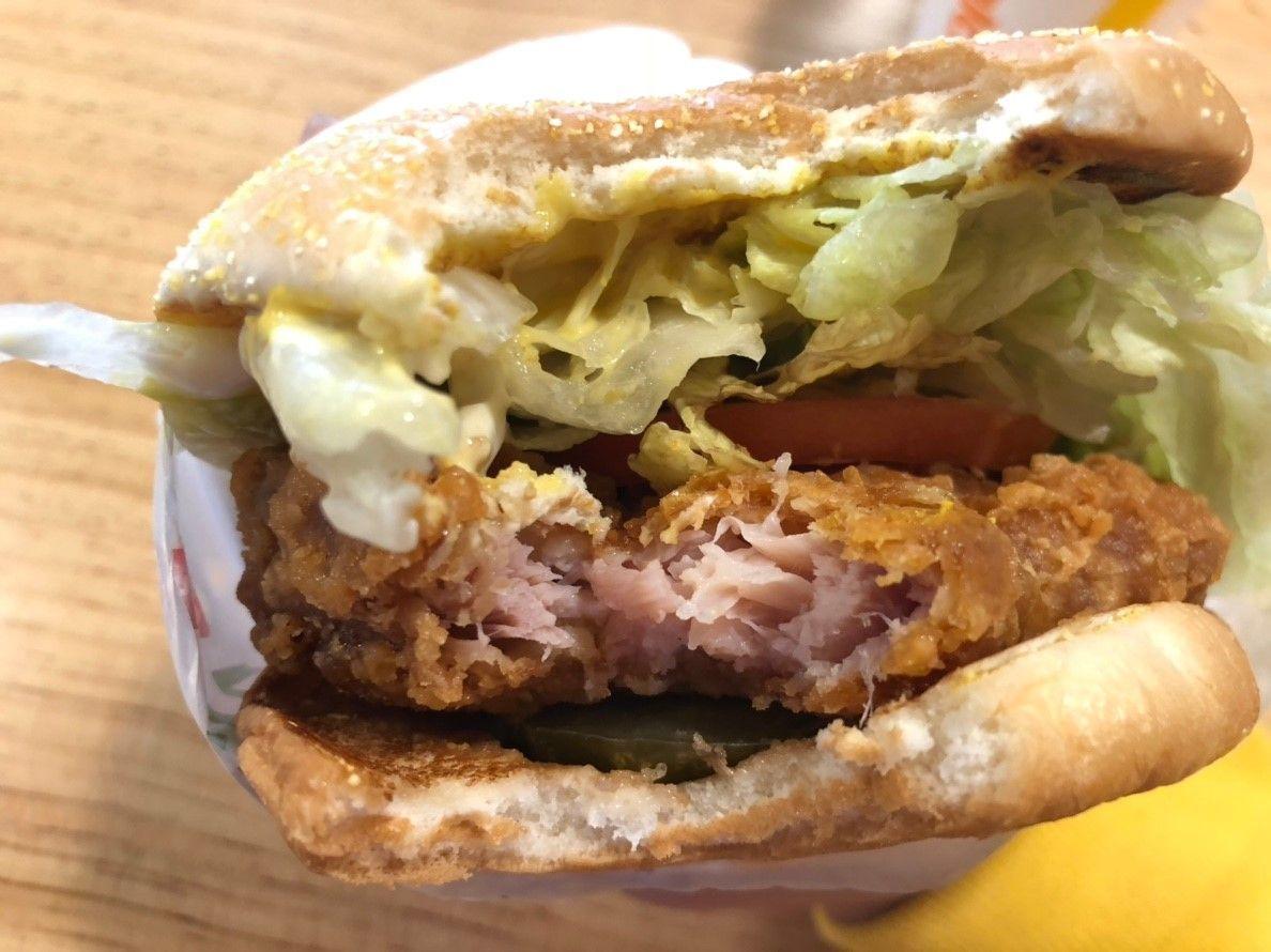Close-up of a Crispy Oriental Chicken Burger from McDonald's Korea with ingredients visible.